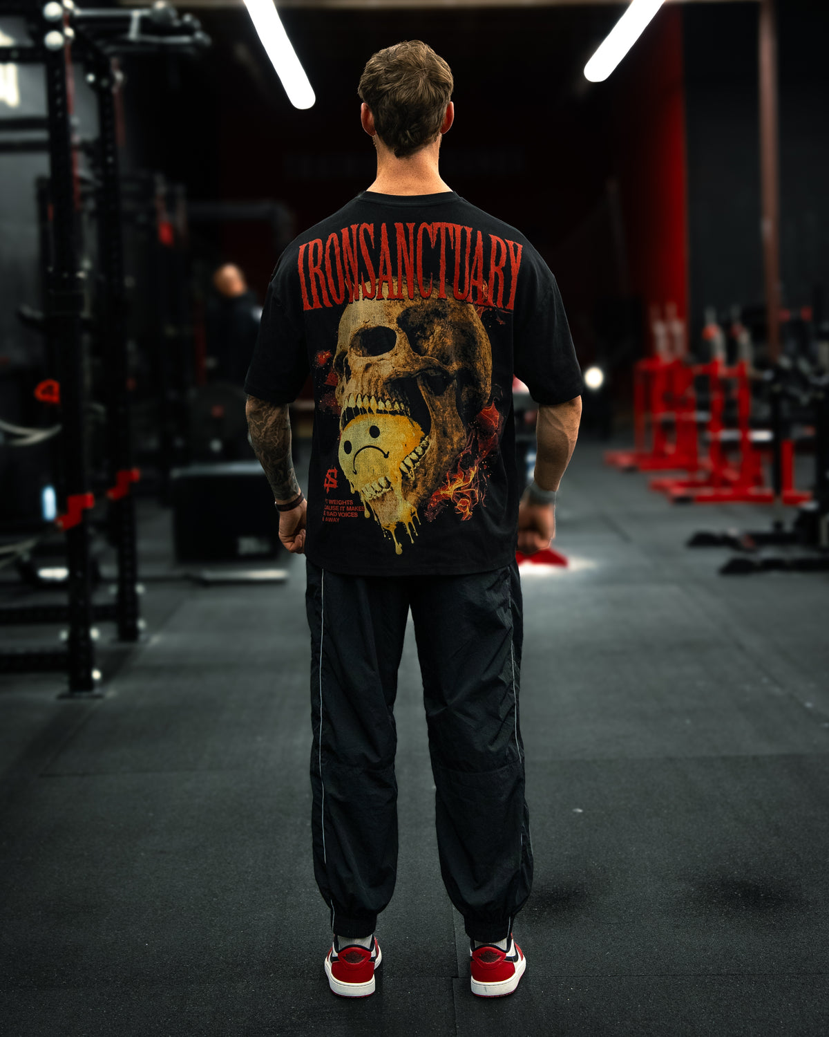 Sad Voices V6 oversized pump cover tee, back view on model in gym