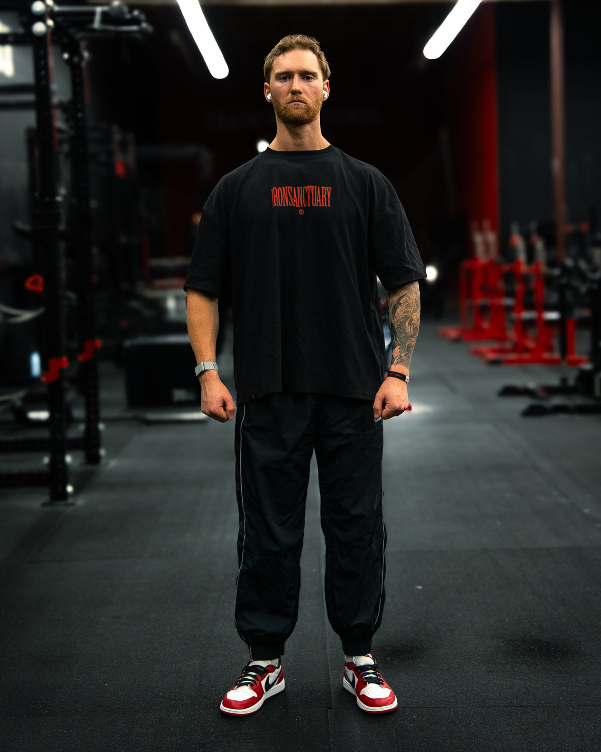 Sad Voices V6 oversized pump cover tee, front view on model in gym